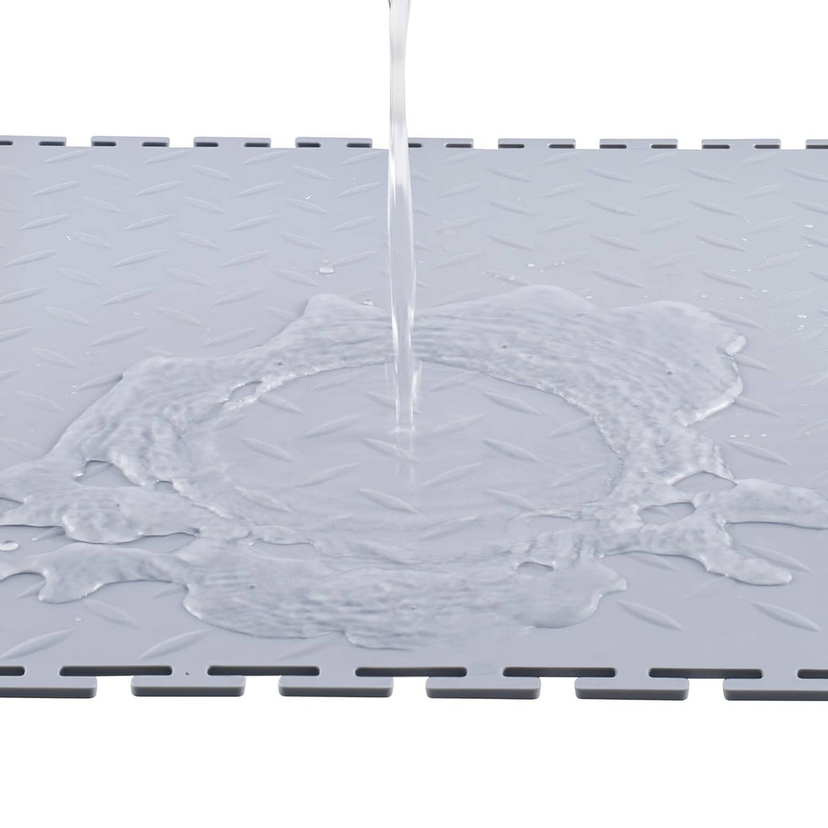 Interlocking PVC garage floor tile, light gray with raised diamond texture and border tabs