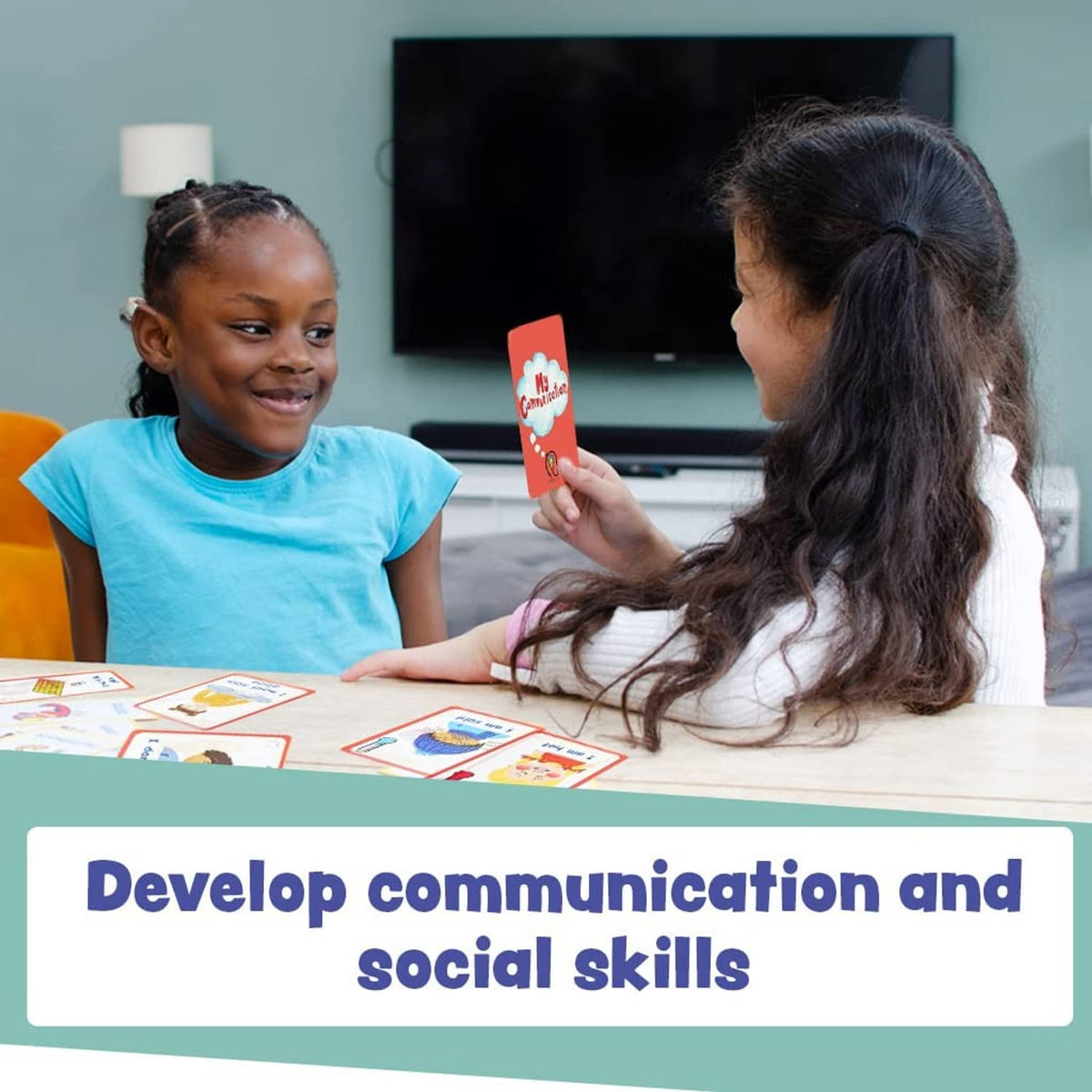 Child and adult using red-framed communication cards on a table
