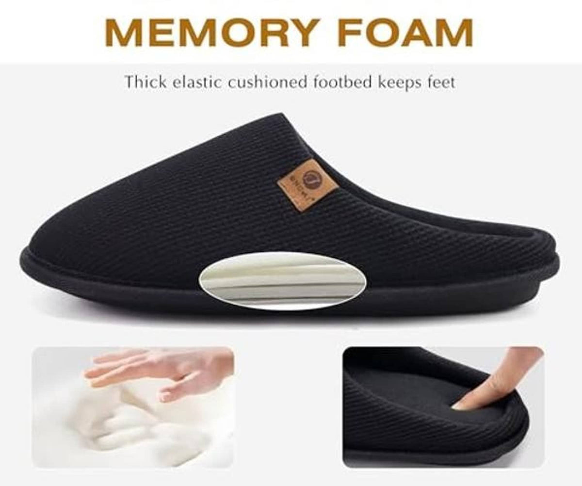 Black memory foam house slipper with cushioned molded footbed and slip-on design.