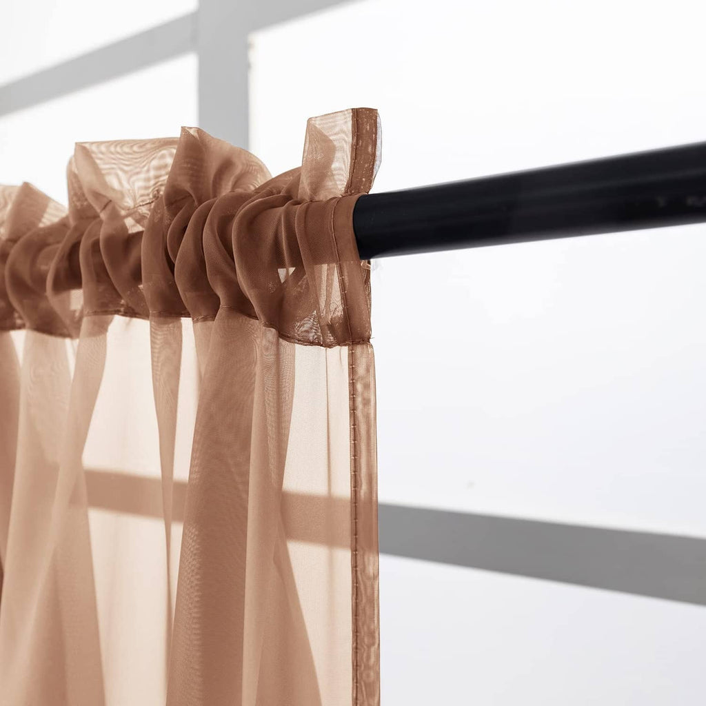 Brown sheer valance curtain gathered on a rod pocket with soft flowing drape