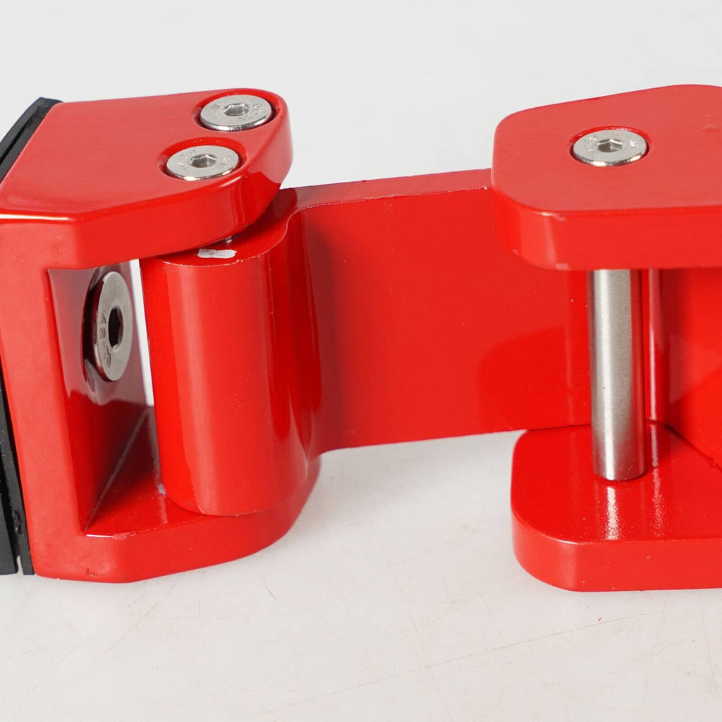 Red hood latch lock with silver mounting pins and black striker, close-up detail