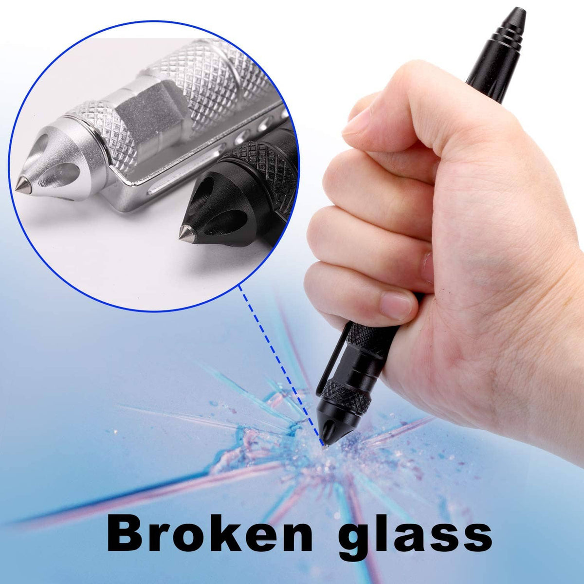 Hand holding black tactical ballpoint pen with metal tip near broken glass