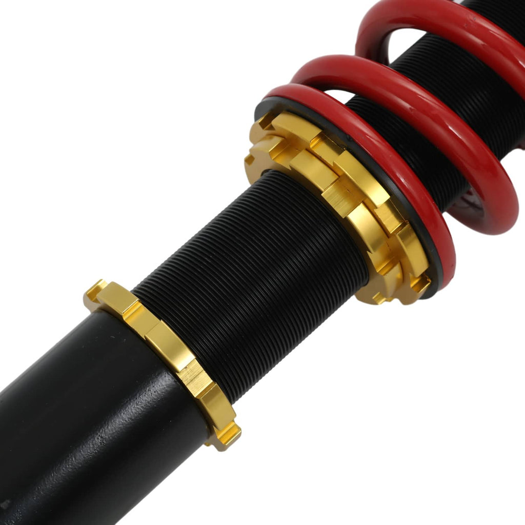 Black coilover damper with red spring and gold ring collar hardware