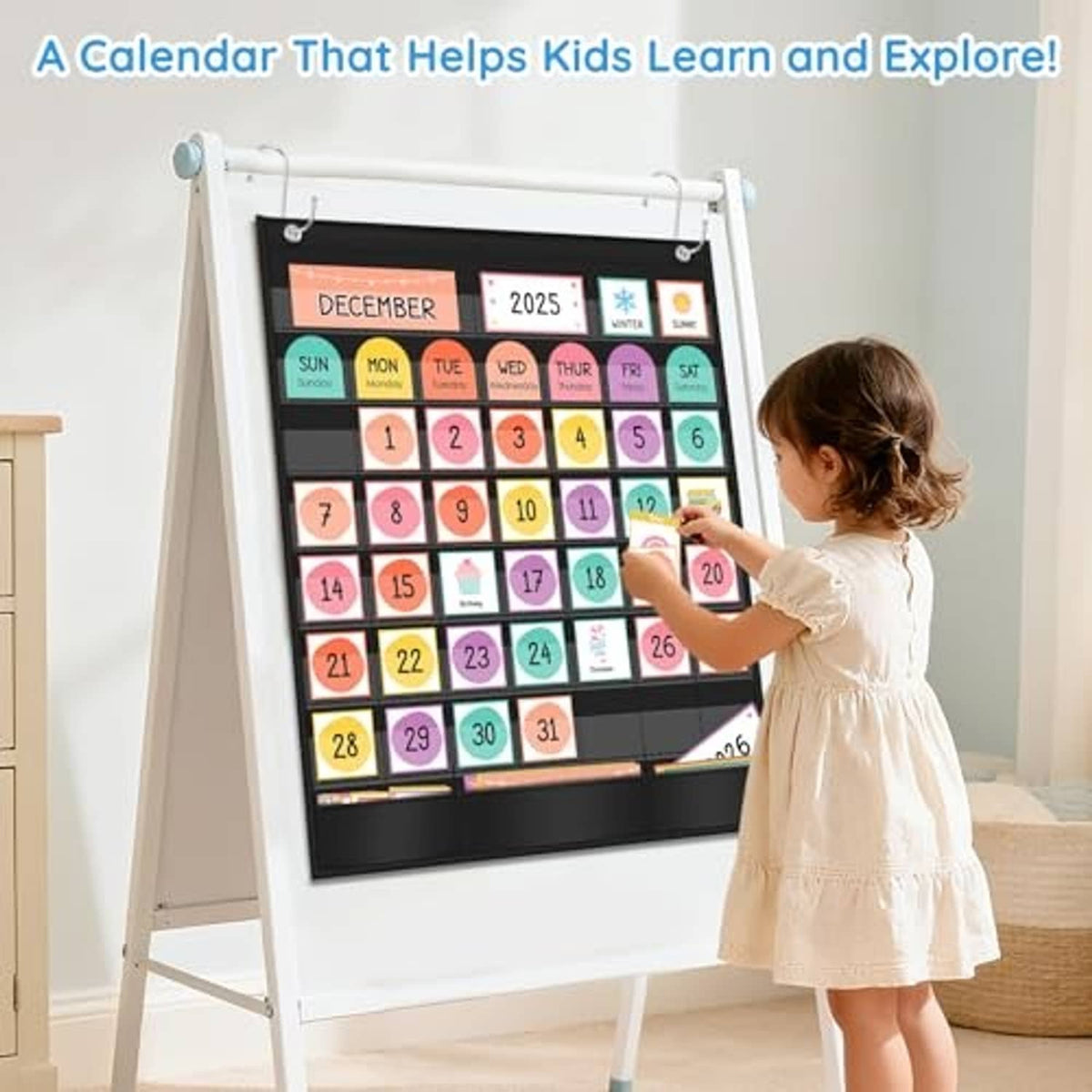 Child pointing at colorful educational calendar pocket chart with hanging pockets, black frame