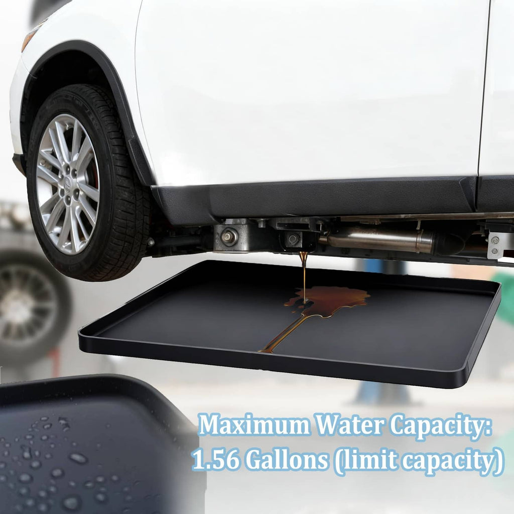 Black under-car drip pan positioned under a car with a visible fluid puddle