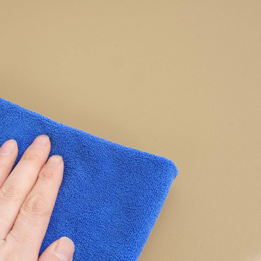 Textured upholstery fabric swatch, blue with visible weave and folded edge