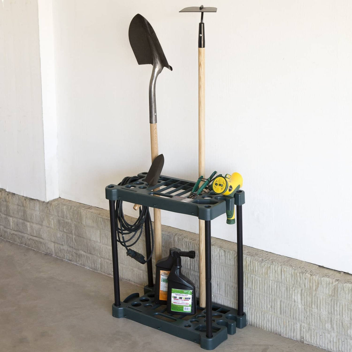 Dark green 2-tier utility rack with open grid shelves for storing garden tools