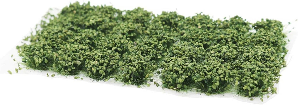 Green bushy shrub tuft strip set on a white tray base