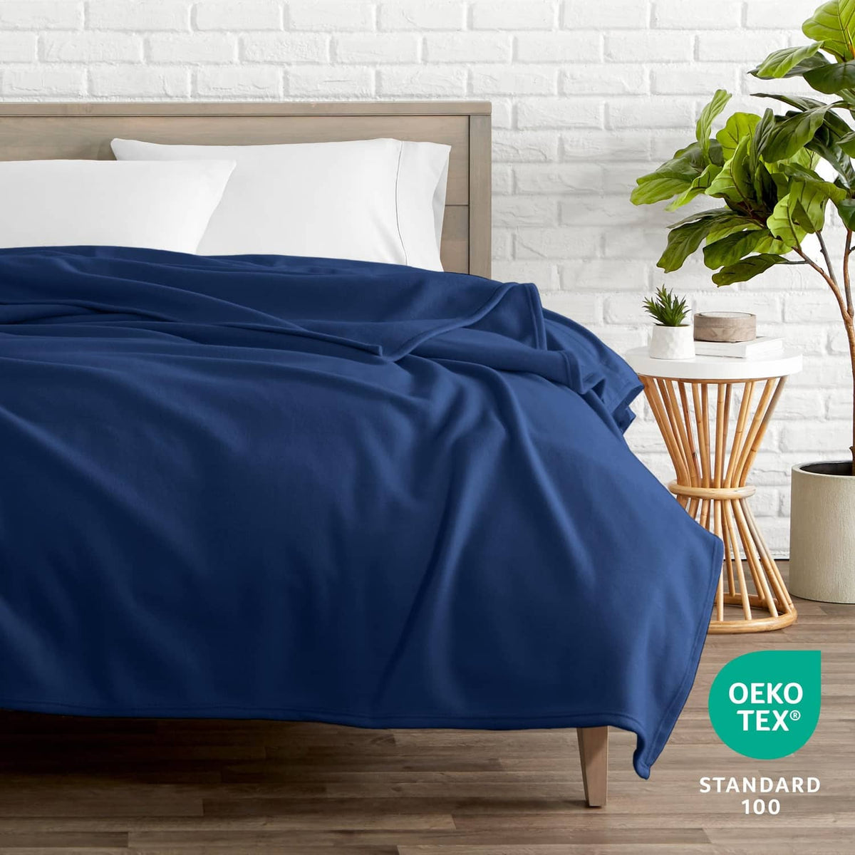 Dark blue blanket laid across a bed, smooth drape with visible folds