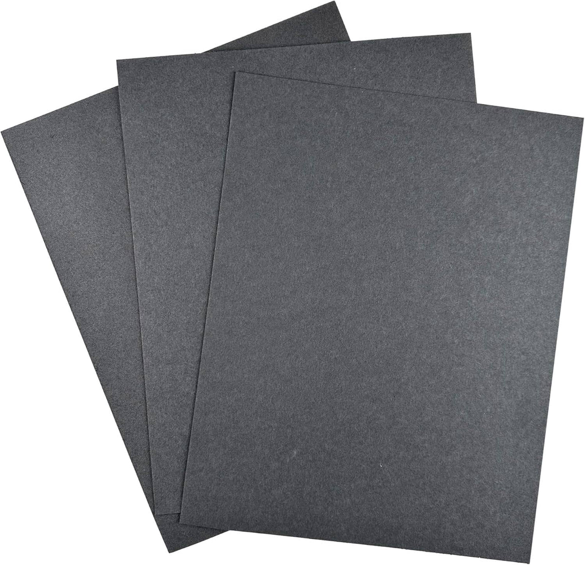 Three dark gray gasket paper sheets laid out together, ready for high-temp sealing
