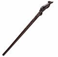 Dark brown carved wooden witch wand with raised creature figure at the top