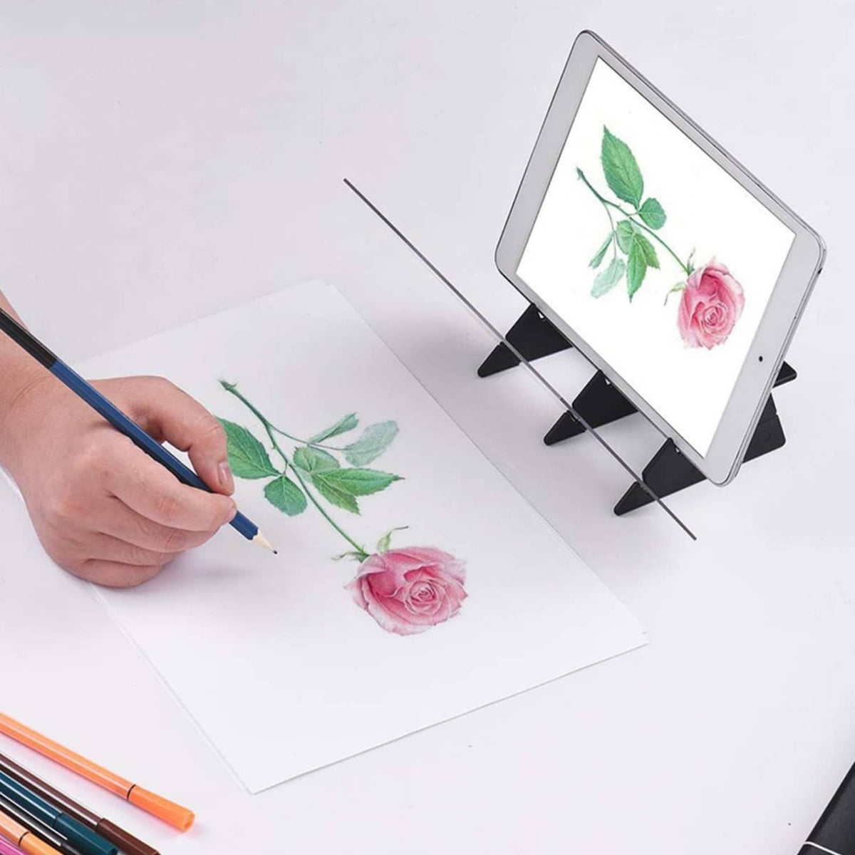 Portable optical tracing board in use with a tablet and black adjustable holder