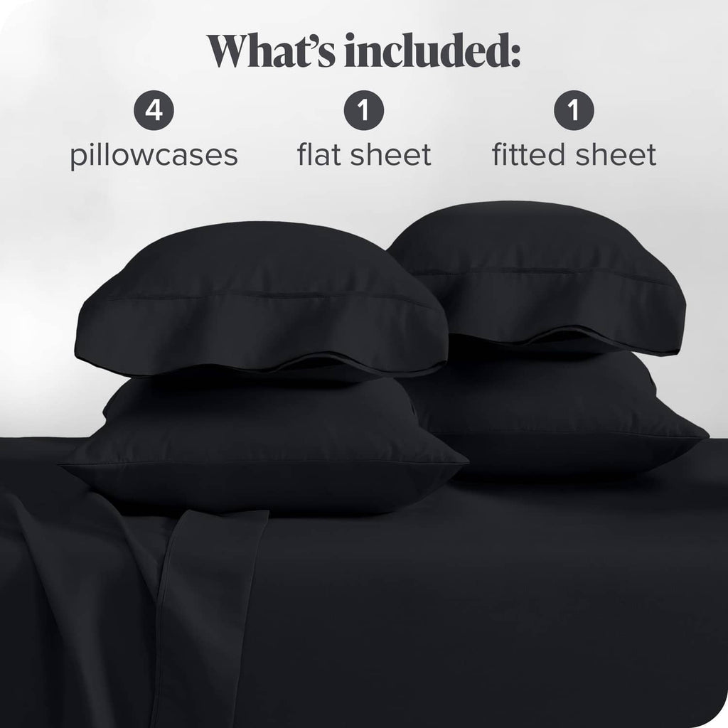 Black bed sheet set with four pillowcases, flat and fitted sheets, folded.
