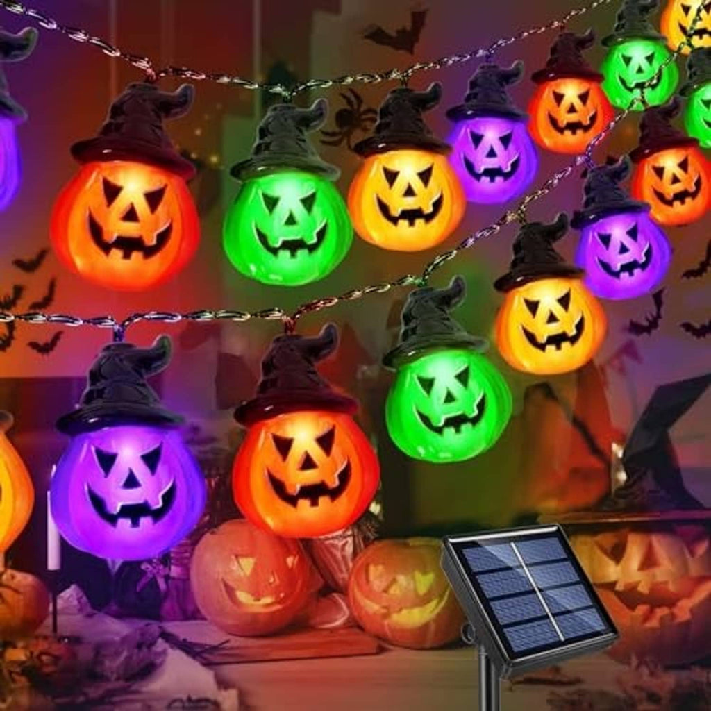 Solar pumpkin string lights with glowing jack-o'-lantern bulbs in orange, green, and purple.