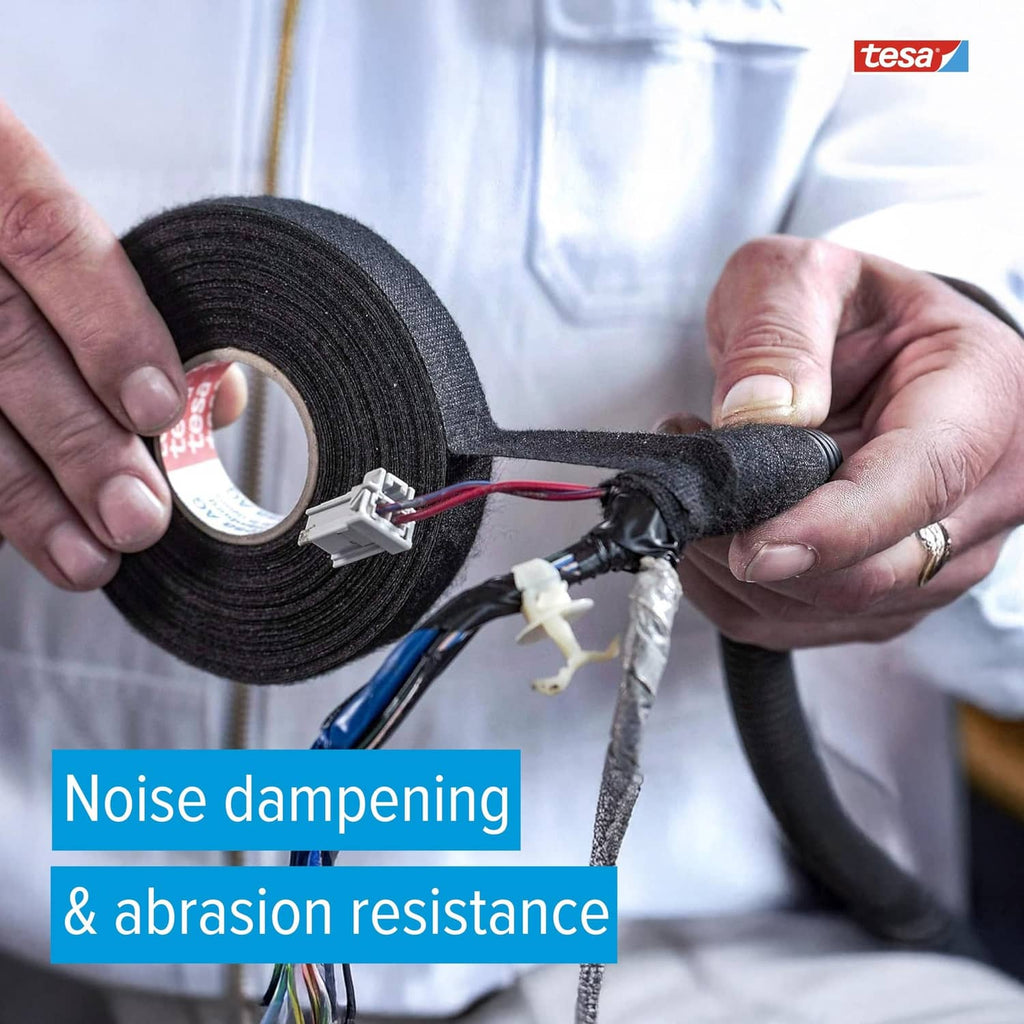 Black tesa noise-damping tape applied to an automotive wire harness by hand
