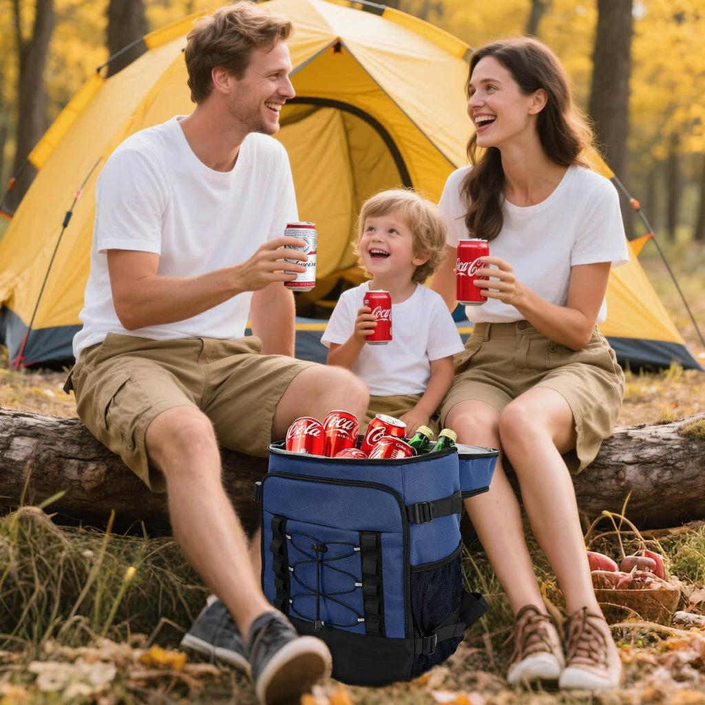 Dark blue cooler backpack on the ground, open top with soda cans and snacks