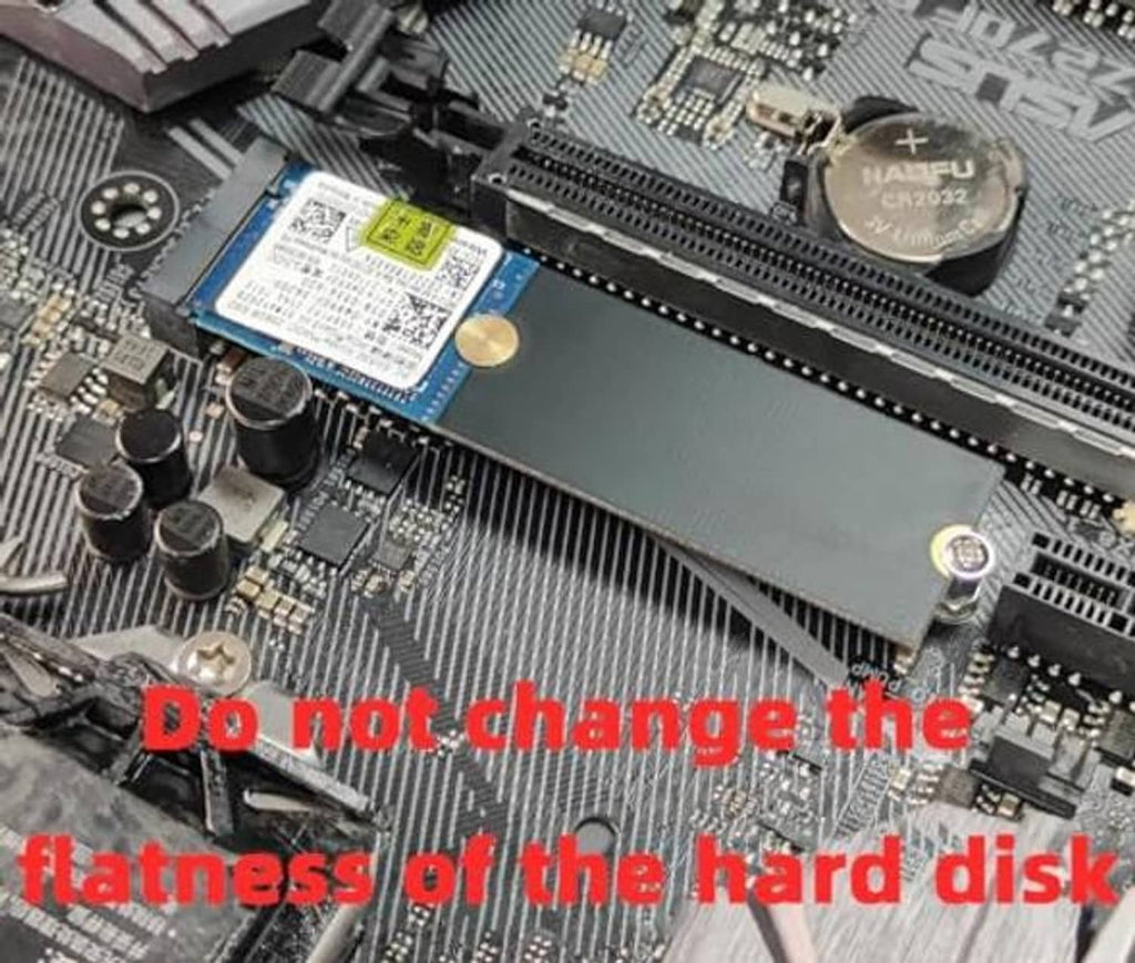 M.2 extension bracket mounted on a motherboard beside an M.2 SSD