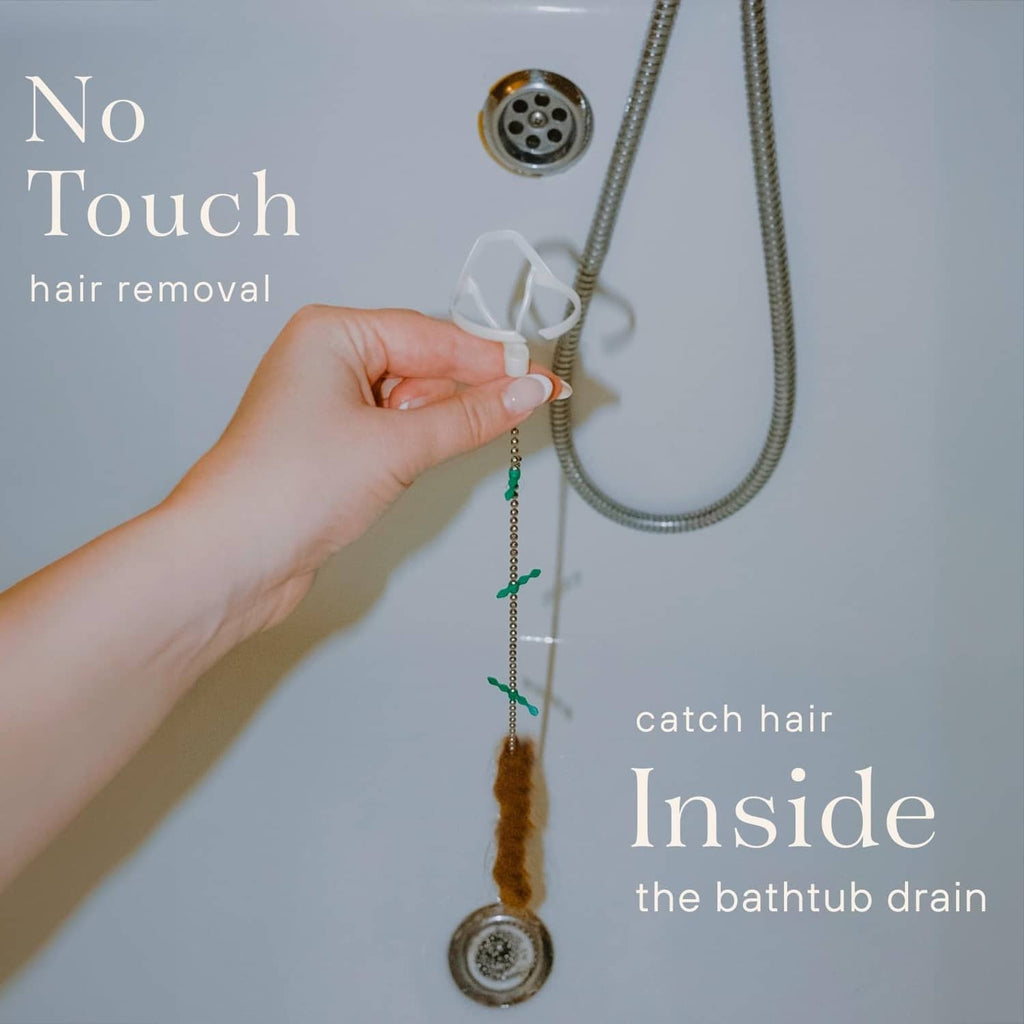 White bathtub drain hair catcher with flexible chain and green whiskers near the drain