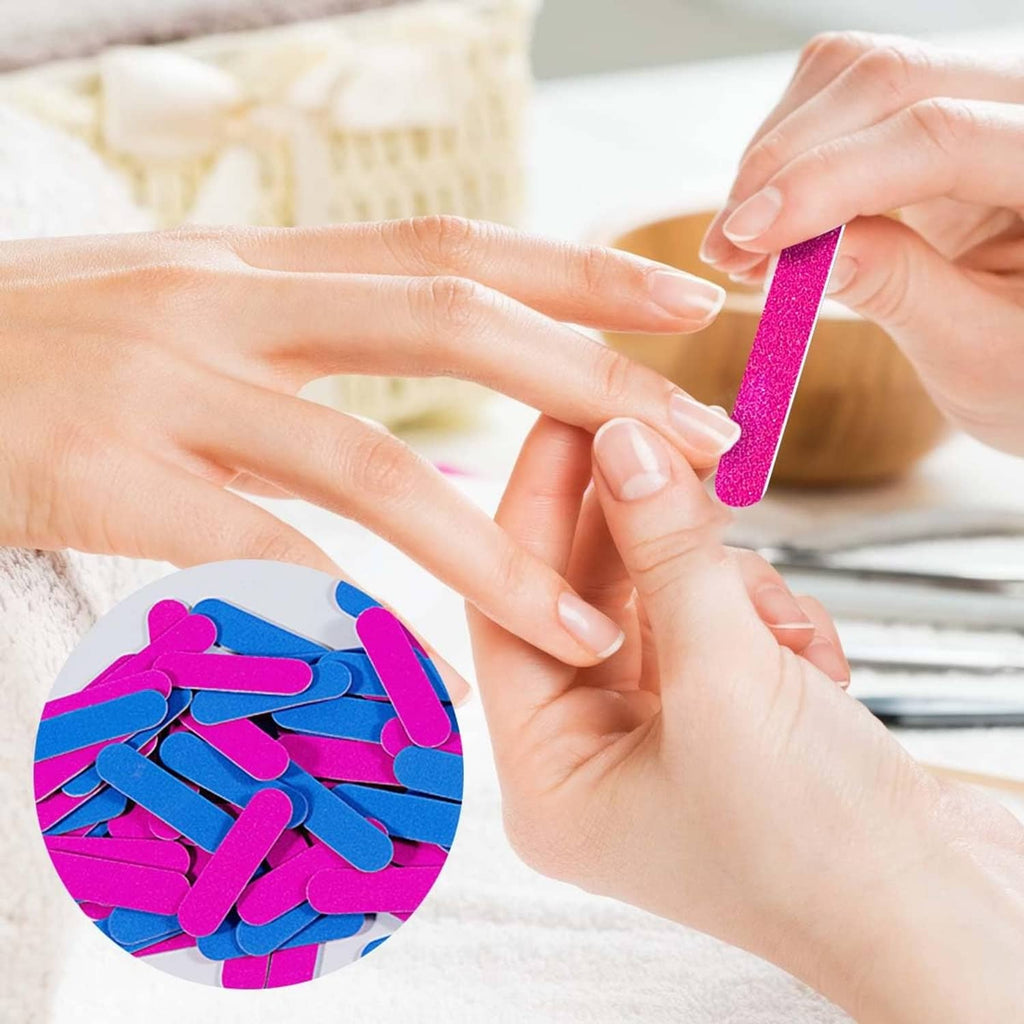 Hand using a pink mini emery nail file on nails, with other files nearby