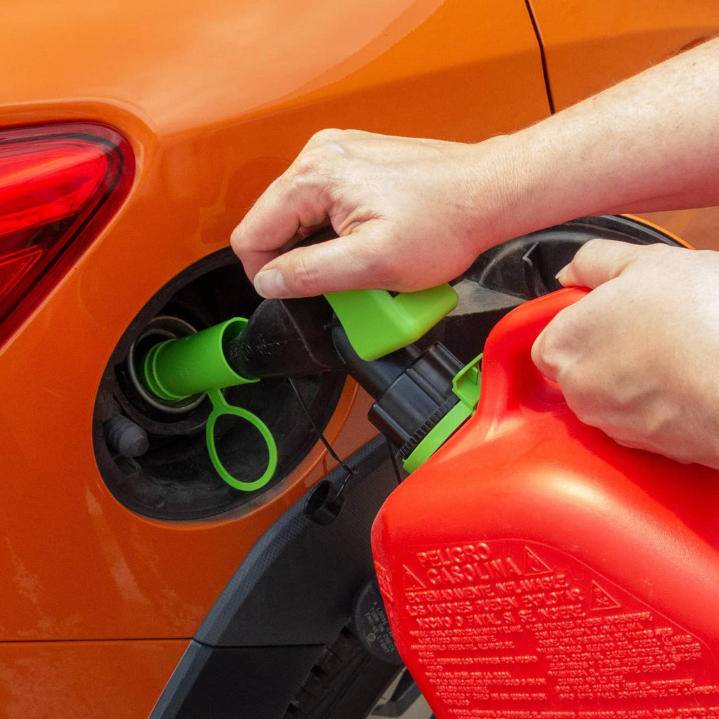 Green funnel spout attachment being installed at a vehicle fuel opening by hand