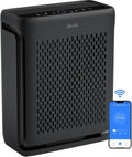 Black Levoit air purifier with perforated front panel and top control buttons.