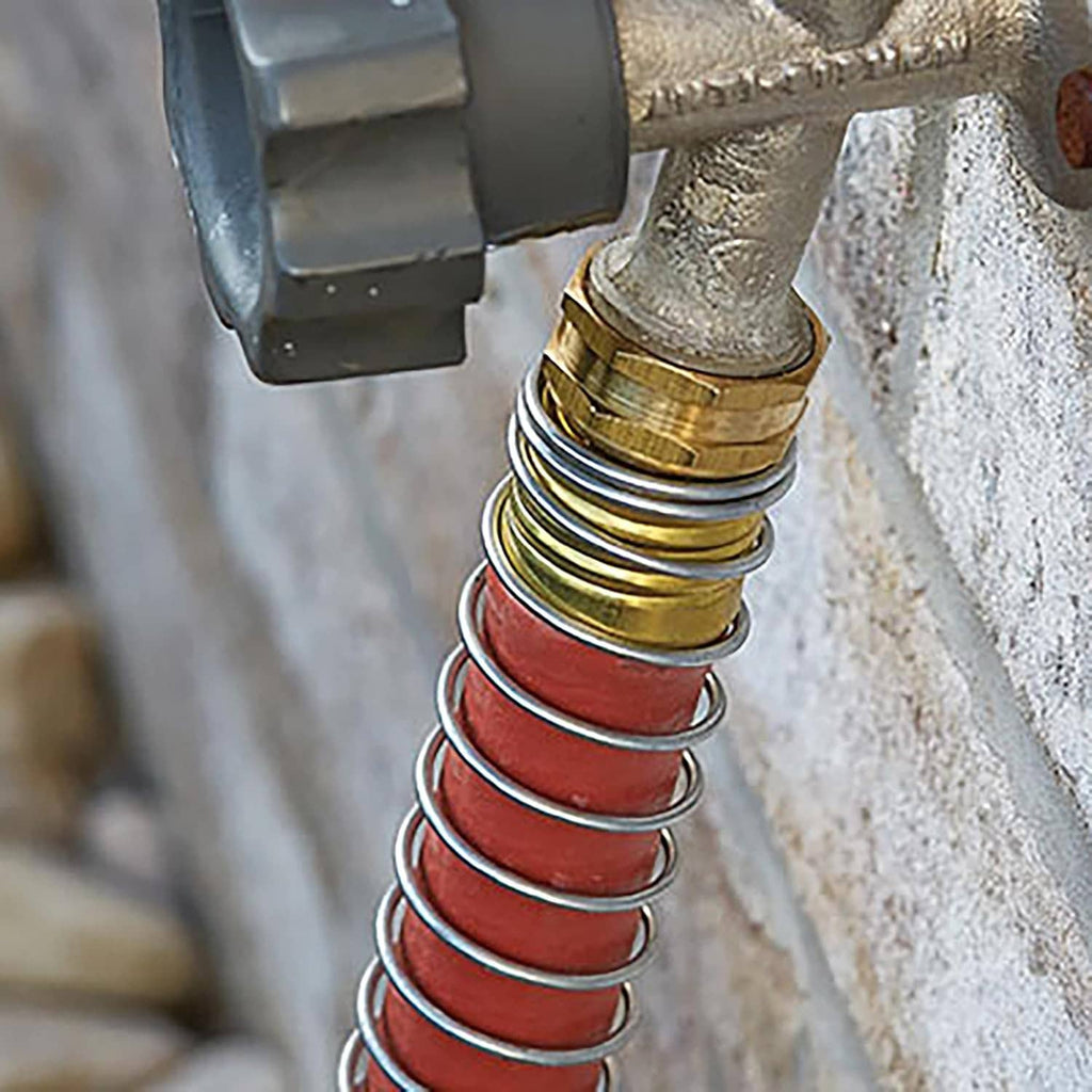 Close-up of red 3/4 in hose connected to a spigot with brass and metal spring.