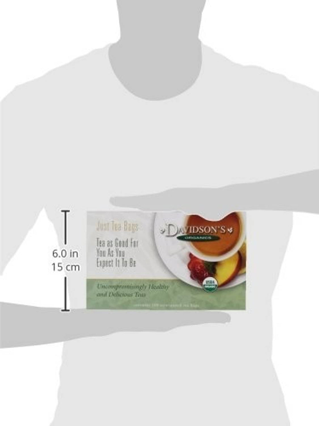 Organic spearmint orange spice tea box shown held at size by a person silhouette