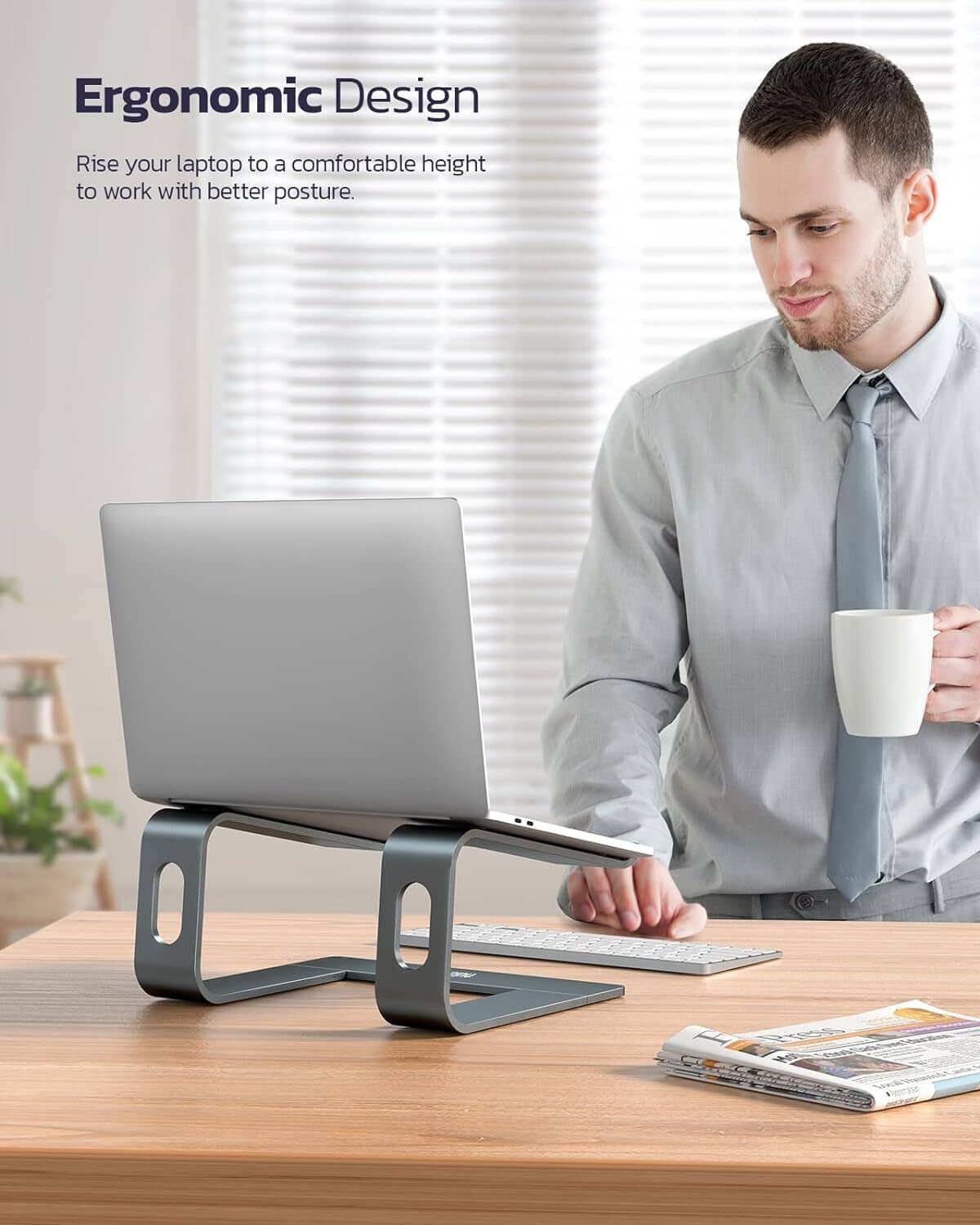 Portable dark gray laptop stand riser showing side cutout support and base