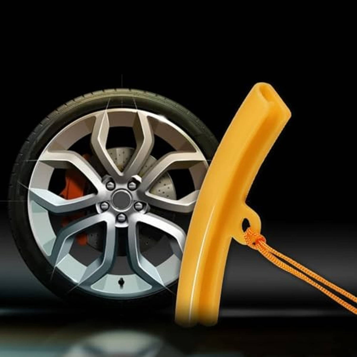 Single orange tire changer rim protector with attached cord lanyard