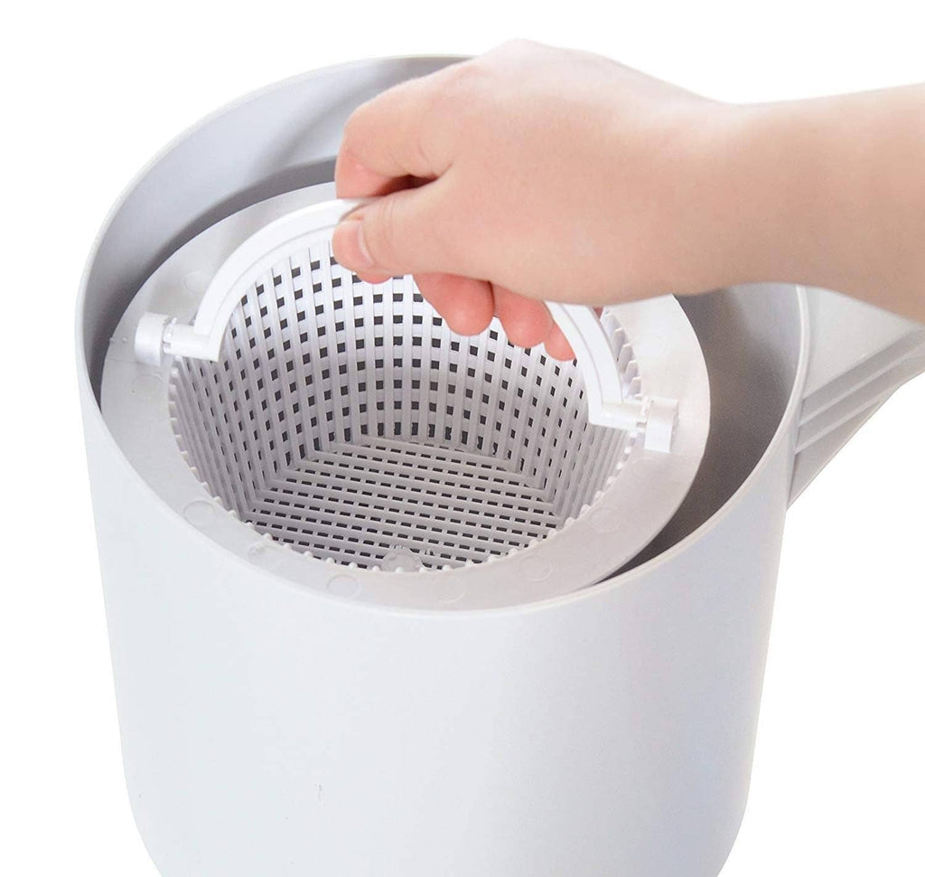 Close-up of a hand placing a white mesh skimmer basket insert into the housing