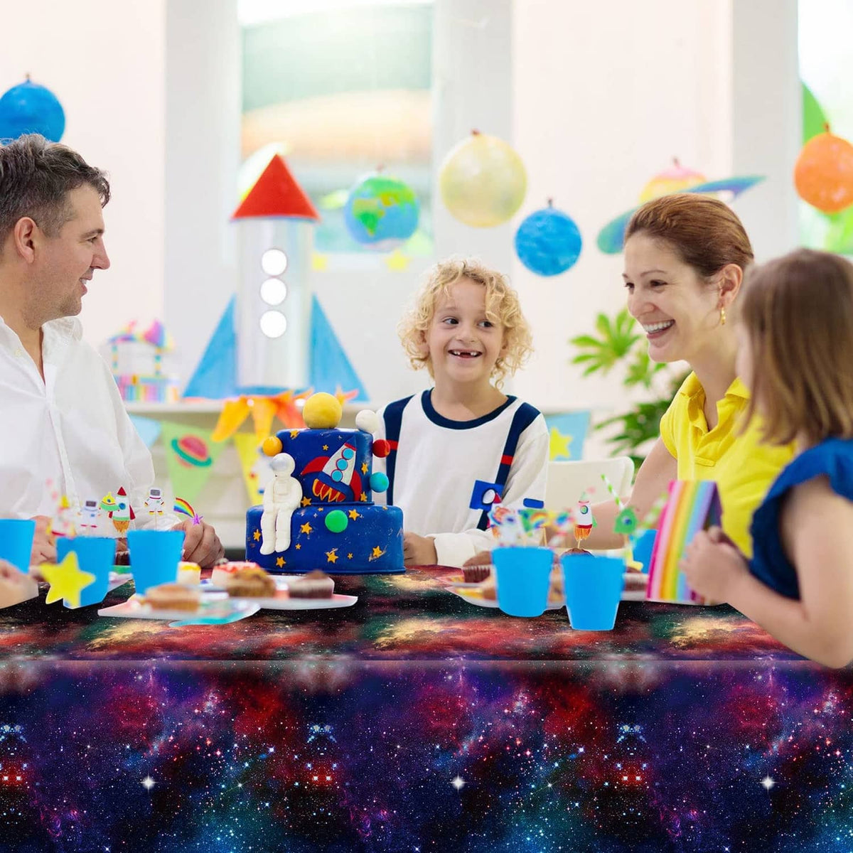Starry galaxy space tablecloth covering party table, dark purple blue nebula print