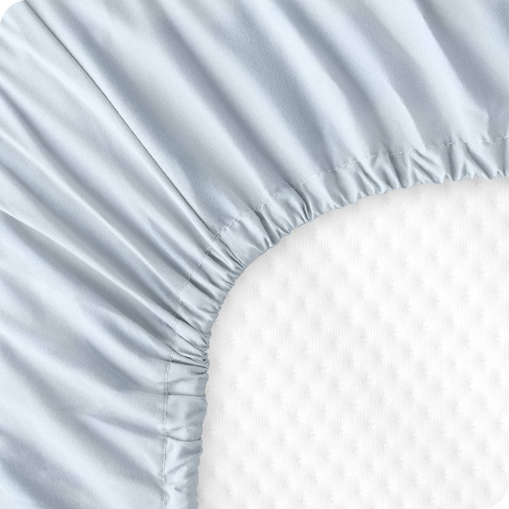 Light sky blue fitted sheet corner with elastic gather and stitched seam