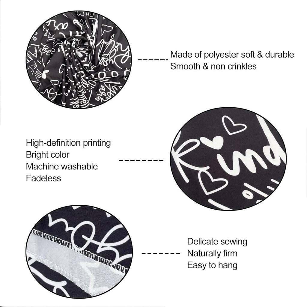 Black and white tapestry fabric close-up with hearts and chalk-style script print