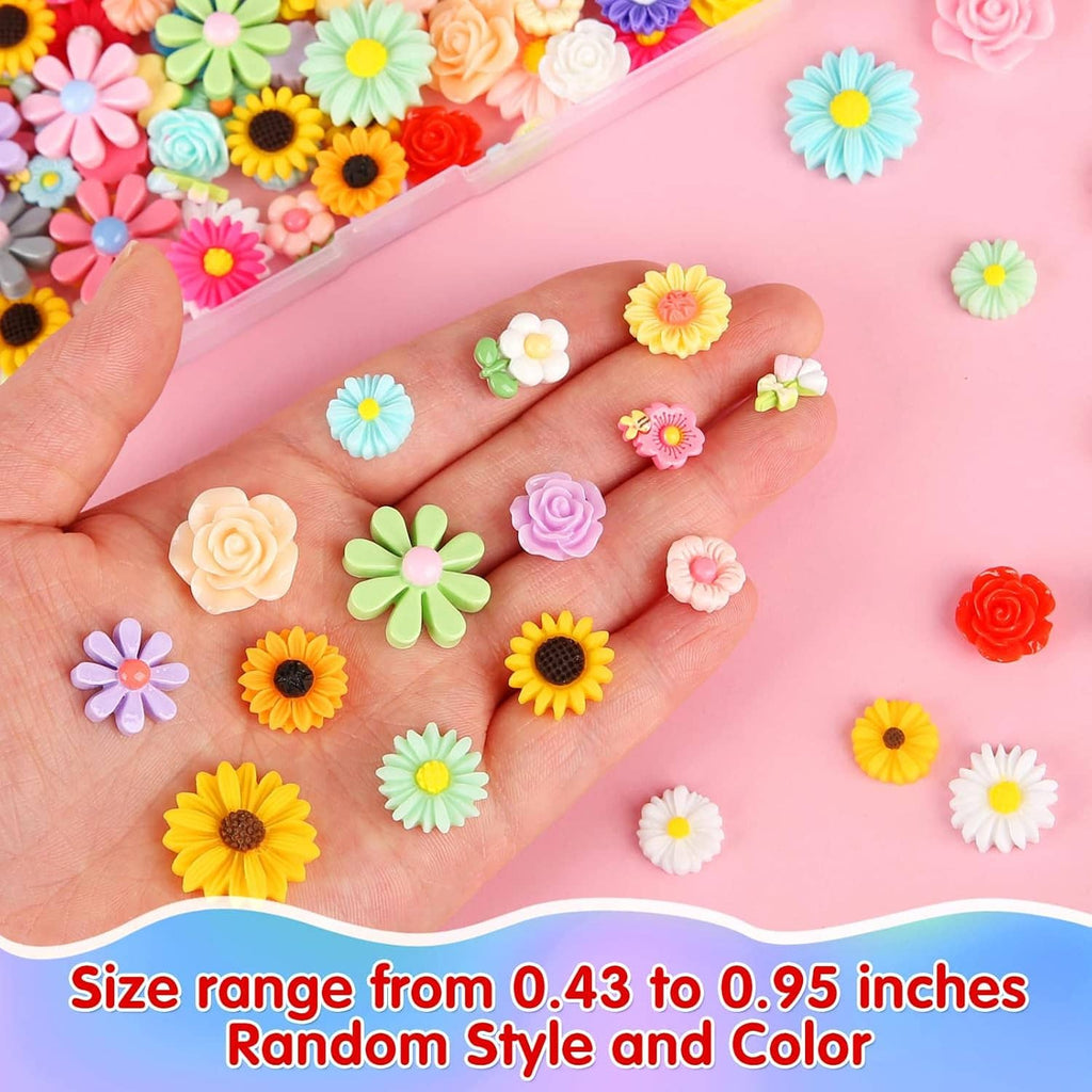Hand holding assorted mini flatback resin flowers, various colors