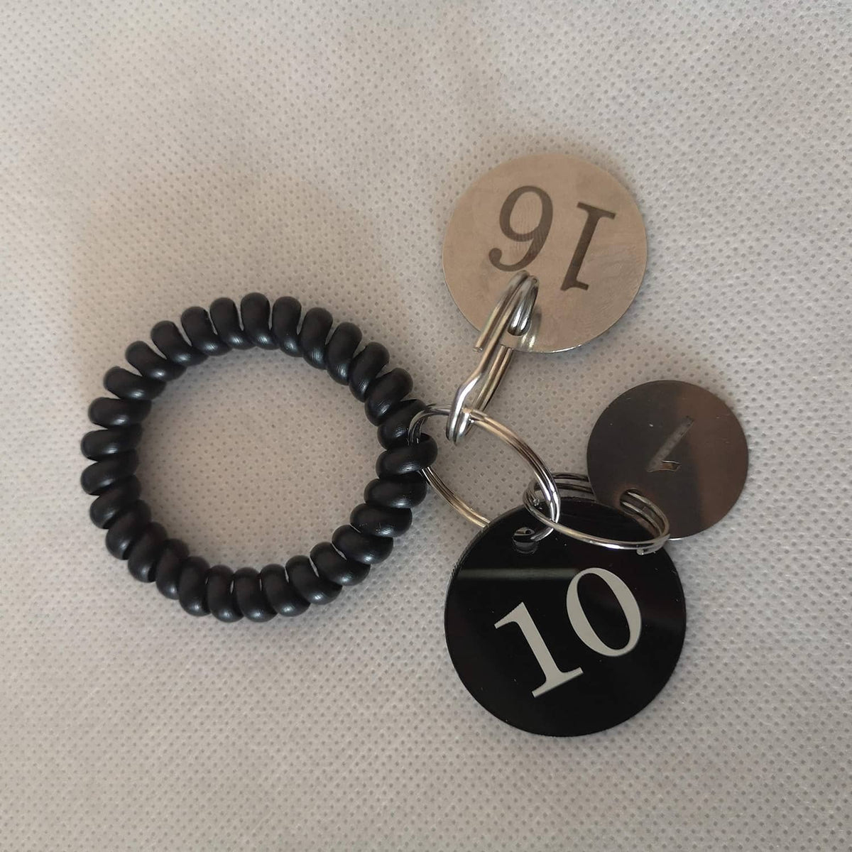 Stainless steel number key tags with rings, showing numbers 7, 9, and 10