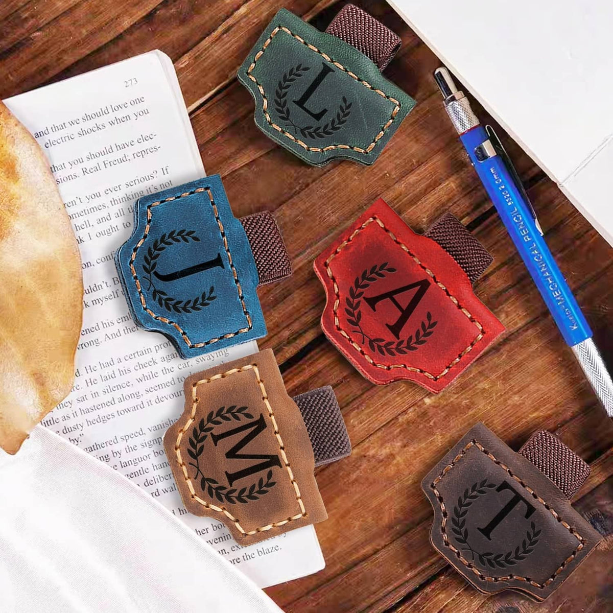 Leather magnetic letter bookmarks with stitched panels and laurel details, assorted colors