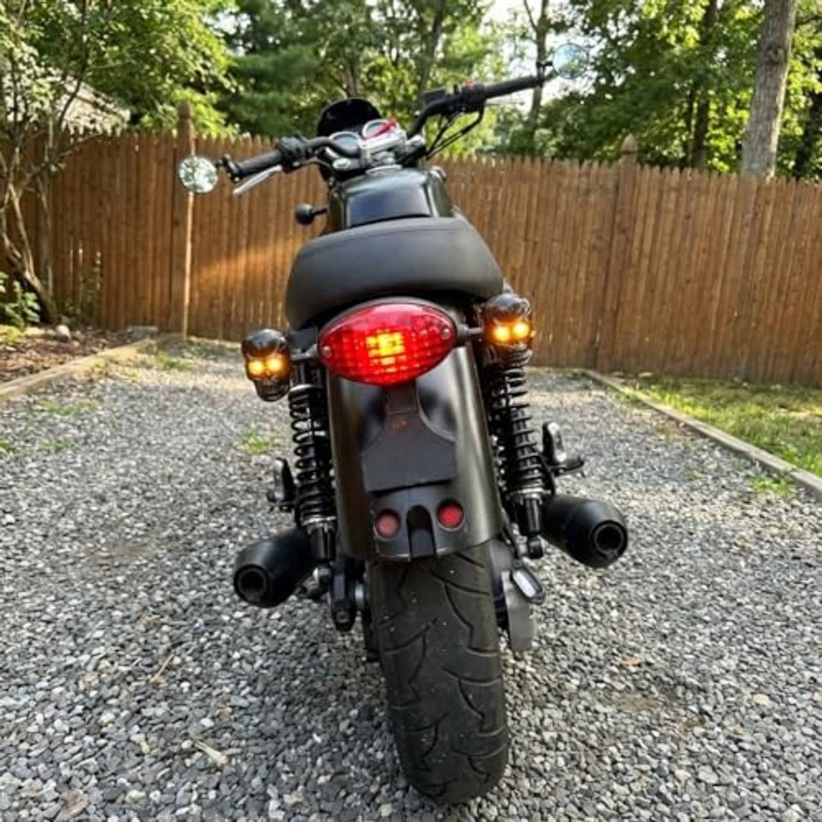 Amber LED turn signals on black motorcycle, skull-style housings with glowing lenses