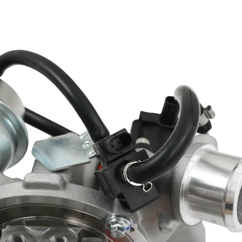 Close-up of turbocharger wiring and black hoses near silver compressor housing