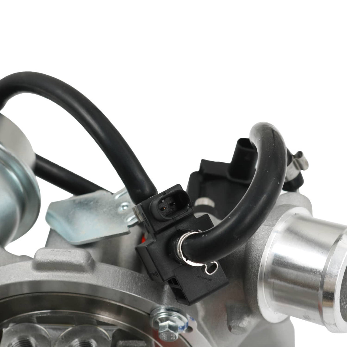 Close-up of turbocharger wiring and black hoses near silver compressor housing