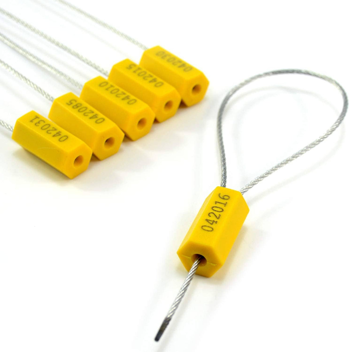 Yellow cable seal tag on steel wire with stacked numbered seals behind