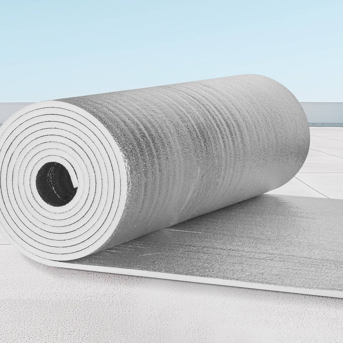 Silver radiant barrier insulation roll on a flat sheet, reflective foil texture