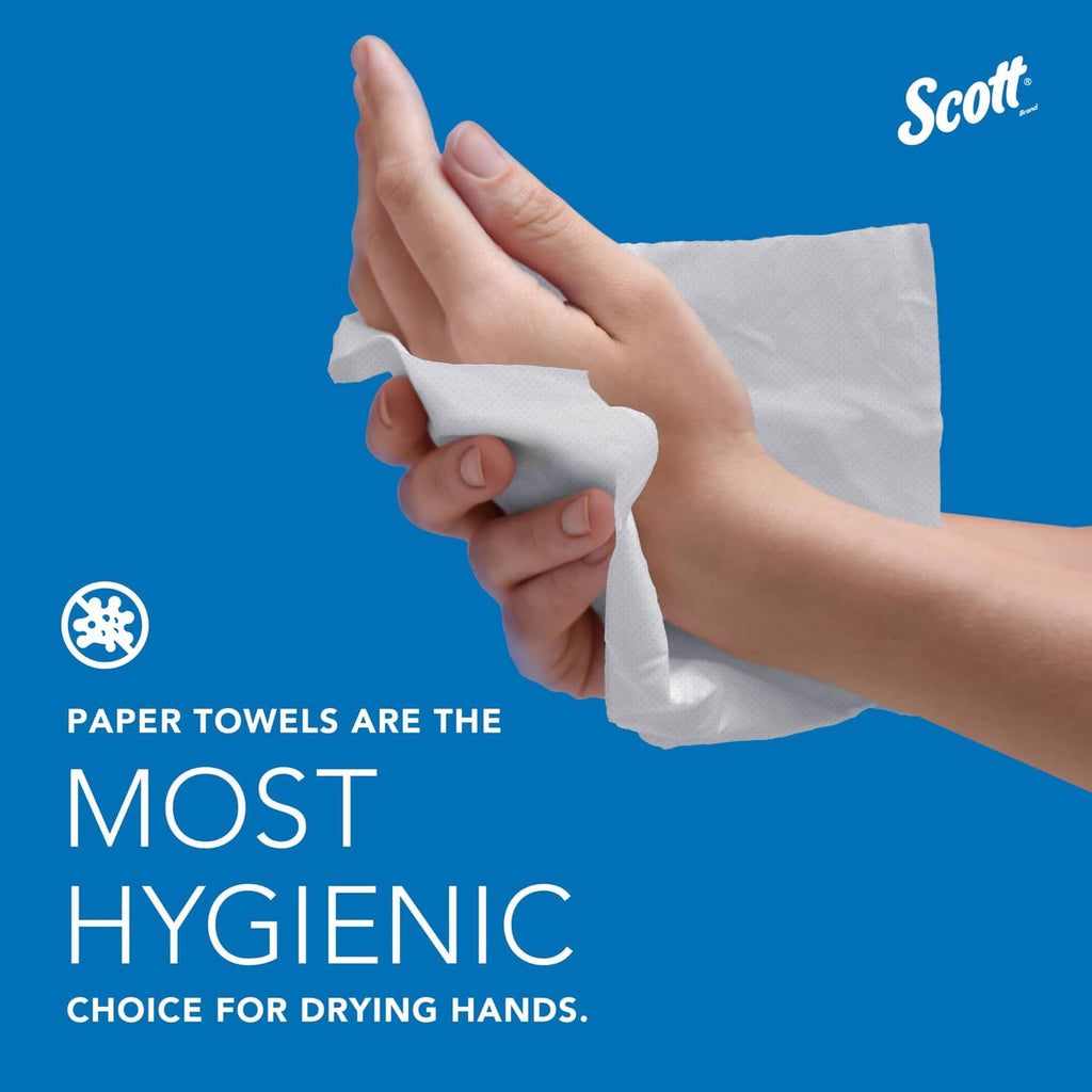 Hand holding a white folded paper towel from a multi-fold stack