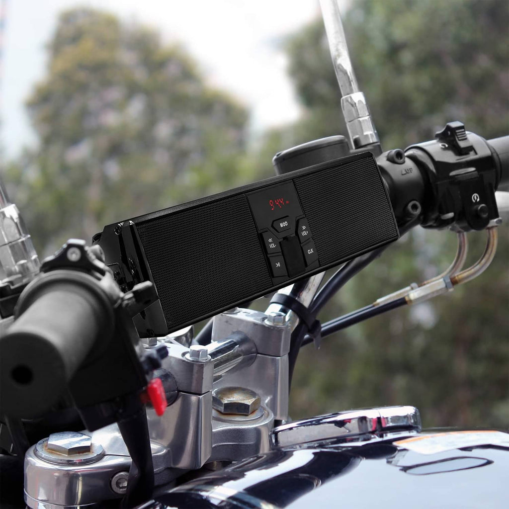 Black motorcycle Bluetooth speaker mounted on handlebars with visible control display.