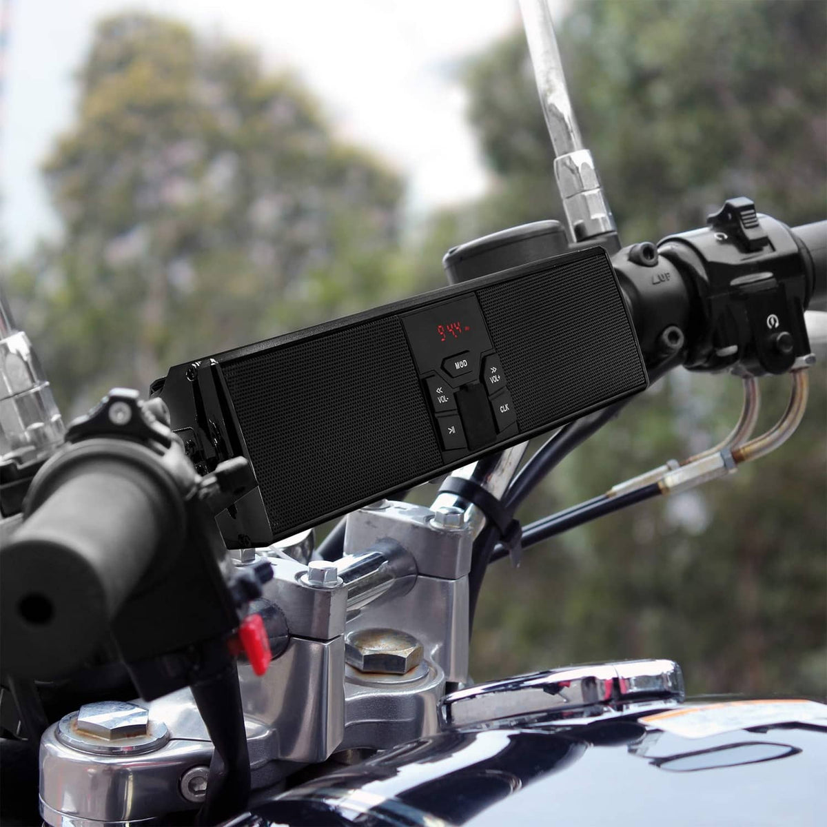 Black motorcycle Bluetooth speaker mounted on handlebars with visible control display.