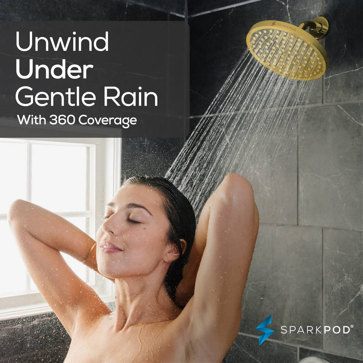 Egyptian gold round rain shower head releasing a wide fan of water