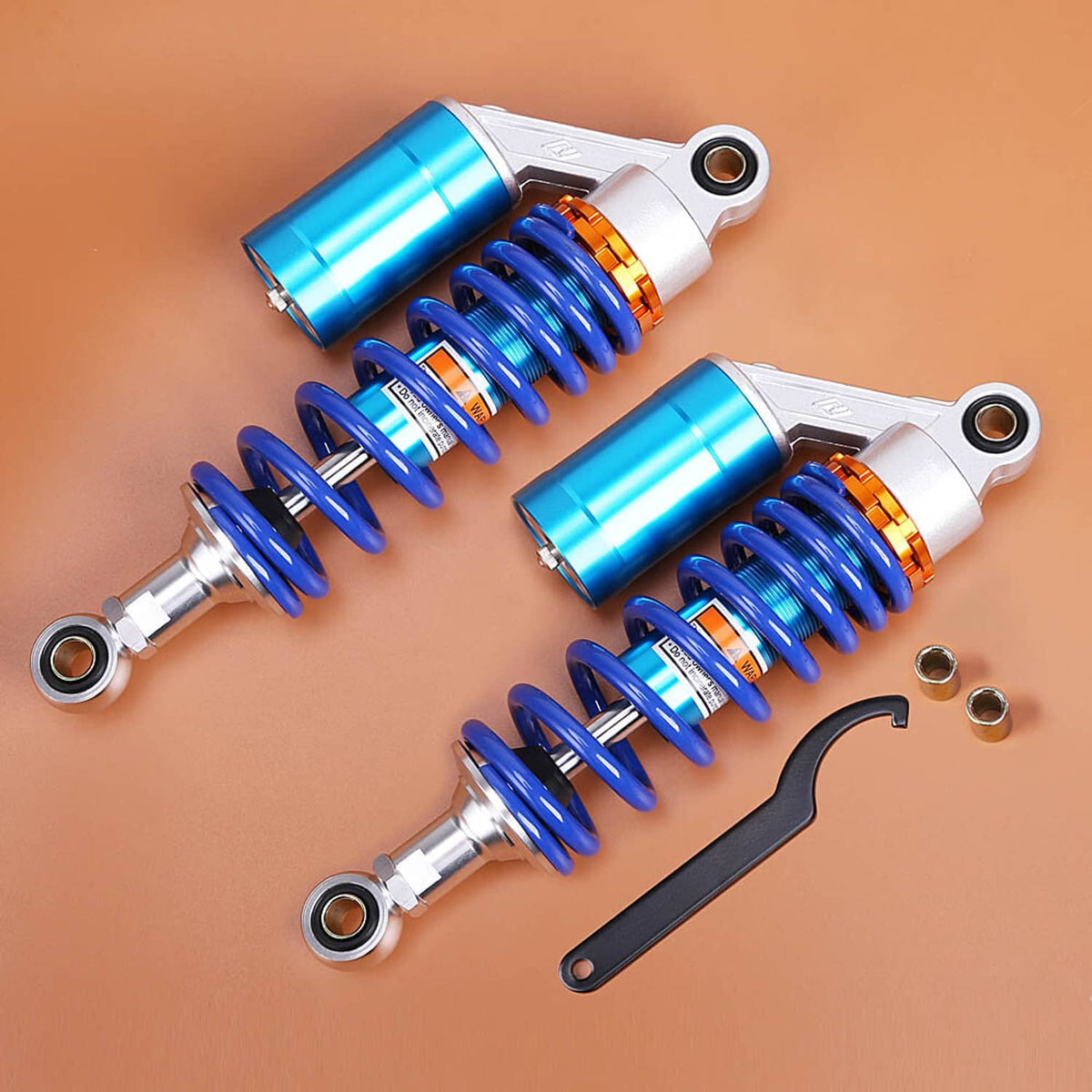 Set of two ATV rear shocks with blue coil springs and orange adjustment rings