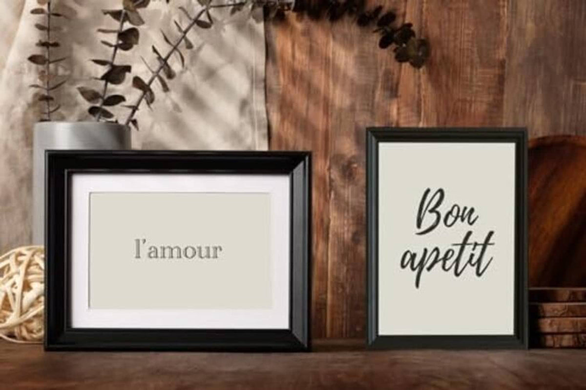 Two black picture frames with white mats and real glass display