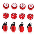 Red dice-style and lantern-style tire valve stem caps set with black rubber rings.