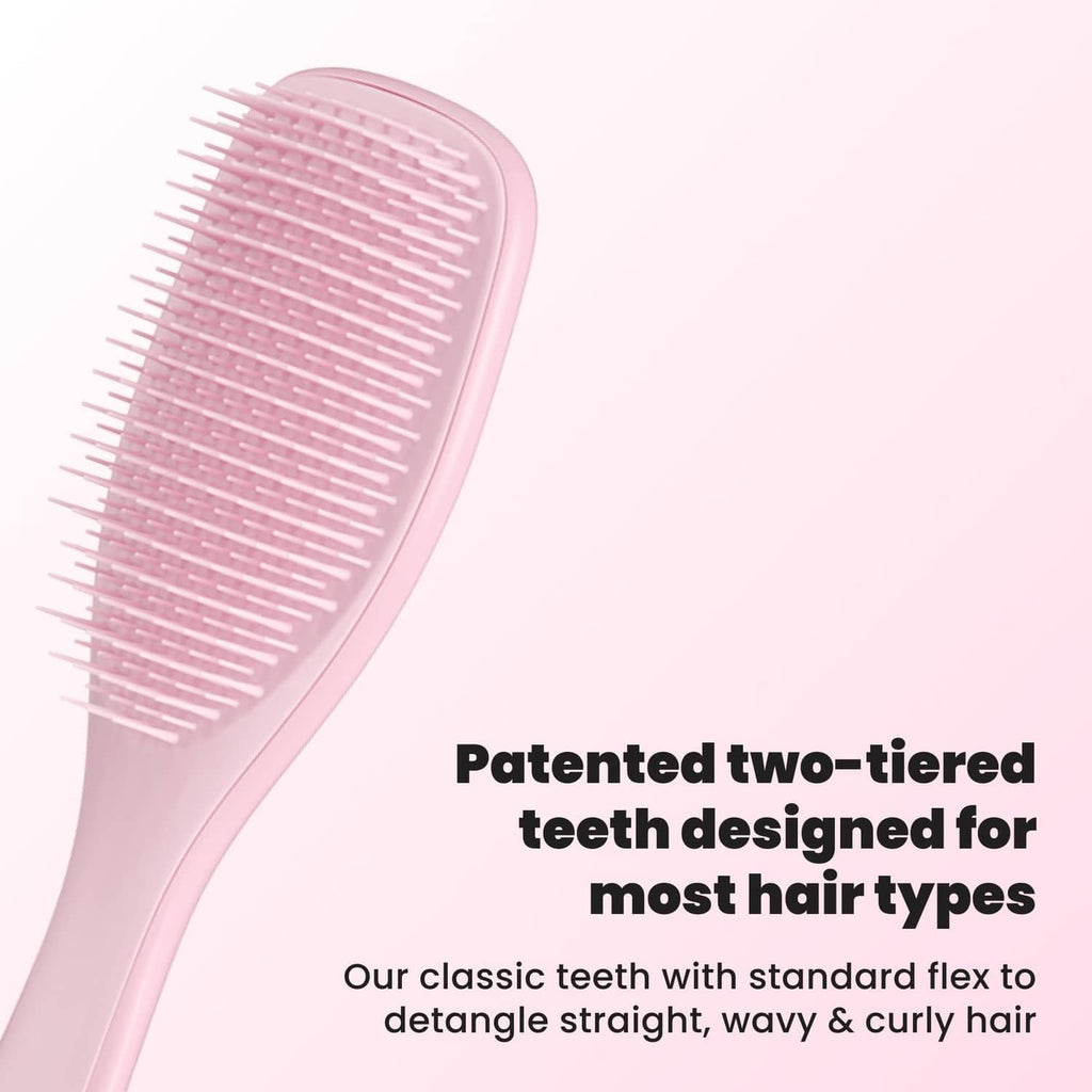 Pink two-tier detangling hairbrush with flexible bristles, side view