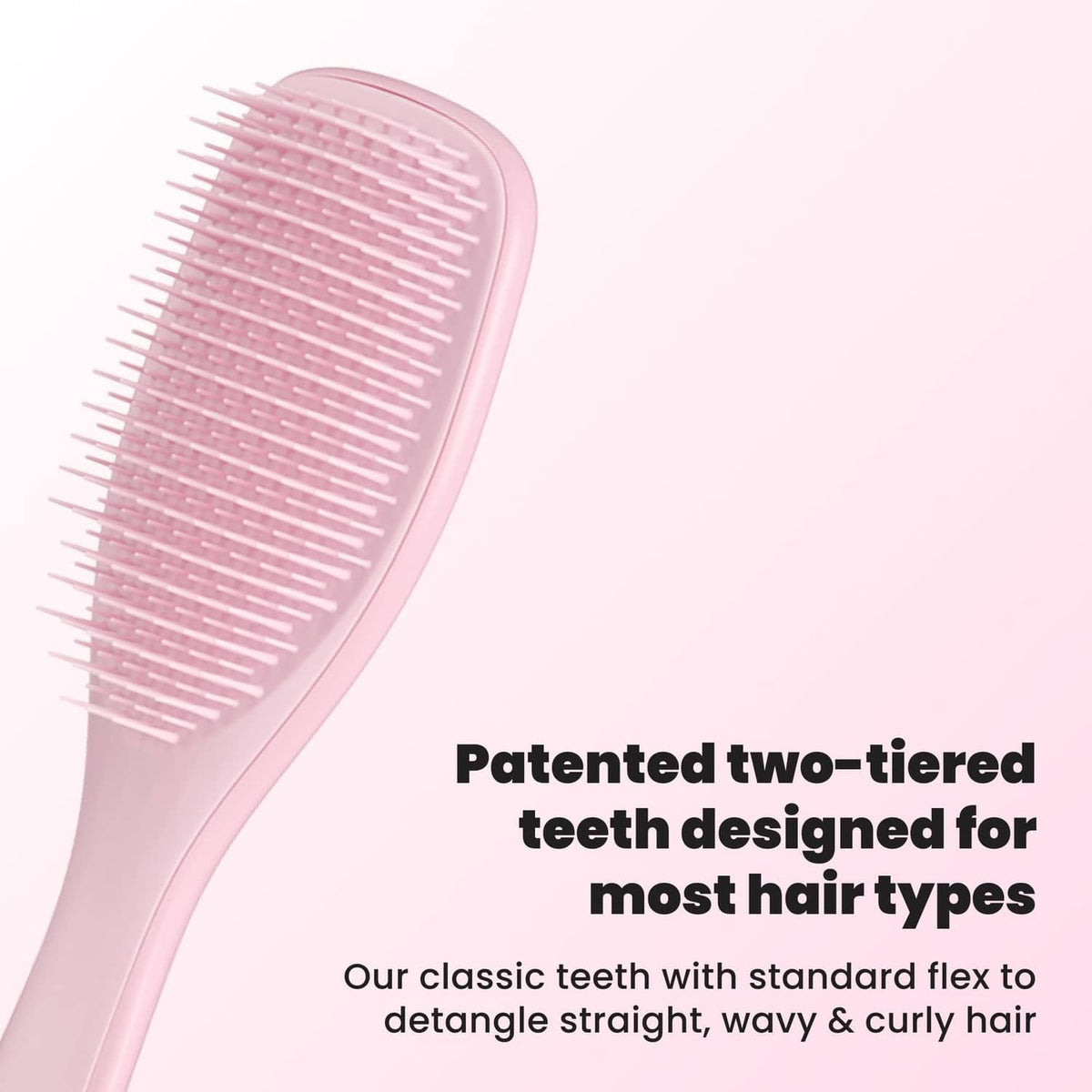 Pink two-tier detangling hairbrush with flexible bristles, side view
